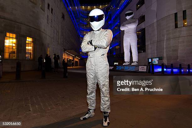 The Stig poses next to a giant statue of The Stig during a photocall to advertise the new series of the BBC's Top Gear programme at BBC Broadcasting...