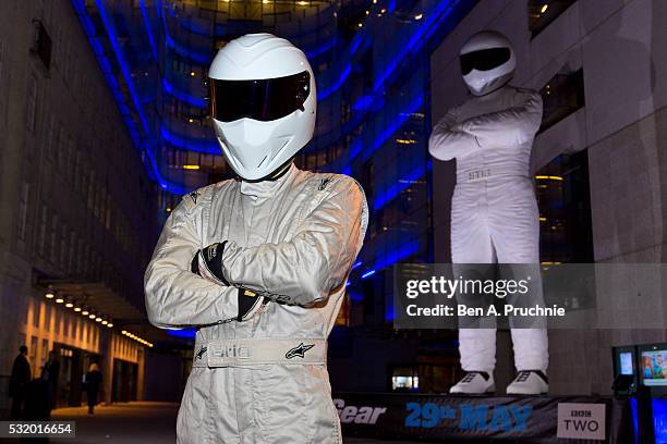 The Stig poses next to a giant statue of The Stig during a photocall to advertise the new series of the BBC's Top Gear programme at BBC Broadcasting...