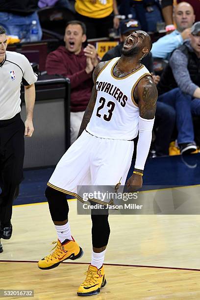 LeBron James of the Cleveland Cavaliers reacts after a basket in the second quarter against the Toronto Raptors in game one of the Eastern Conference...