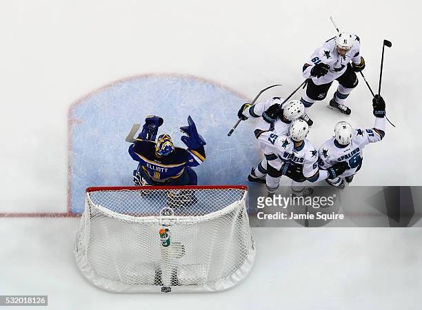 Tommy Wingels of the San Jose Sharks celebrates with teammates after scoring a first period goal against Brian Elliott of the St. Louis Blues in Game...