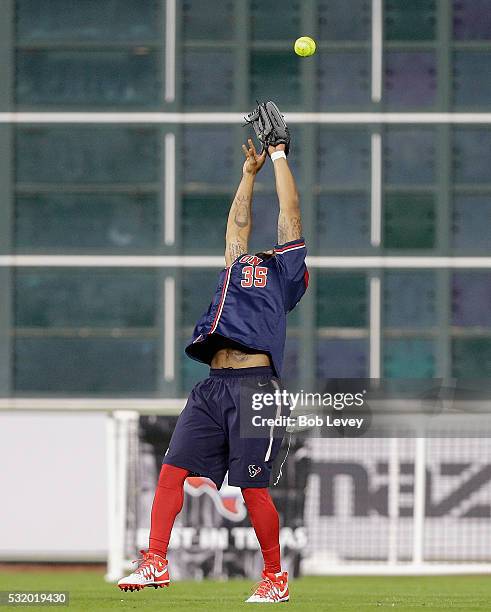 Eddie Pleasant of the Houston Texans makes a leaping catch during the JJ Watt Charity Softball Classic at Minute Maid Park on May 14, 2016 in...