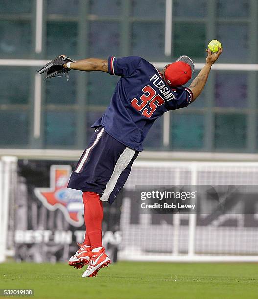 Eddie Pleasant of the Houston Texans makes a leaping catch during the JJ Watt Charity Softball Classic at Minute Maid Park on May 14, 2016 in...