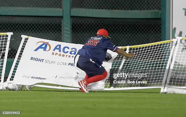 Eddie Pleasant of the Houston Texans leaps at the fence but is unable to make a catch during the JJ Watt Charity Softball Classic at Minute Maid Park...