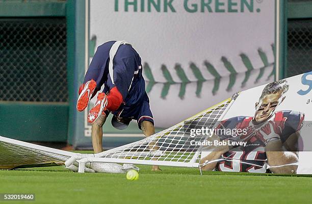 Eddie Pleasant of the Houston Texans leaps at the fence but is unable to make a catch during the JJ Watt Charity Softball Classic at Minute Maid Park...