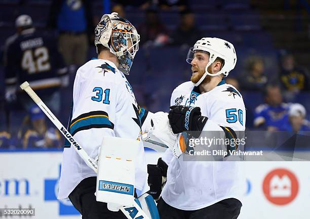 Martin Jones of the San Jose Sharks celebrates with Chris Tierney after defeating the St. Louis Blues 4-0 in Game Two of the Western Conference Final...