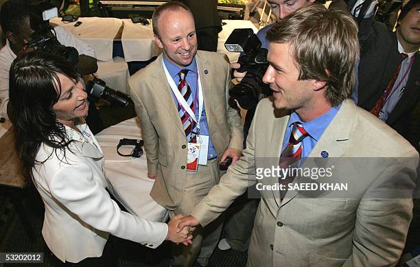 British footballer David Beckham shakes hands with former Romanian gymnast Nadia Comaneci , a supporter for New York's bid, following the...