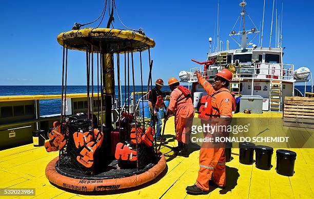 Sailors and workers load members luggage onto the L/B MYRTLE Offshore Support Vessel -a scientific plataform working in the Gulf of Mexico- in front...