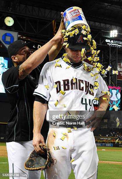 Paul Goldschmidt of the Arizona Diamondbacks gets a bucket of gum and ice water dumped over his head by teammate David Peralta after a 5-3 win...