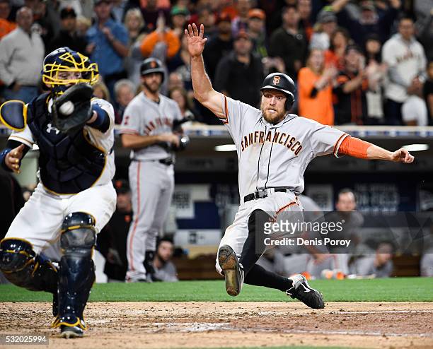 Hunter Pence of the San Francisco Giants scores as Derek Norris of the San Diego Padres fields the ball during the eighth inning of a baseball game...