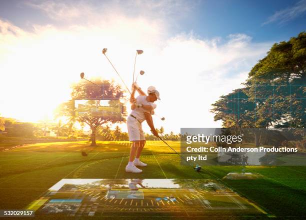 multiple exposures of caucasian golfer hitting ball on course surrounded by holograms - golf swing foto e immagini stock