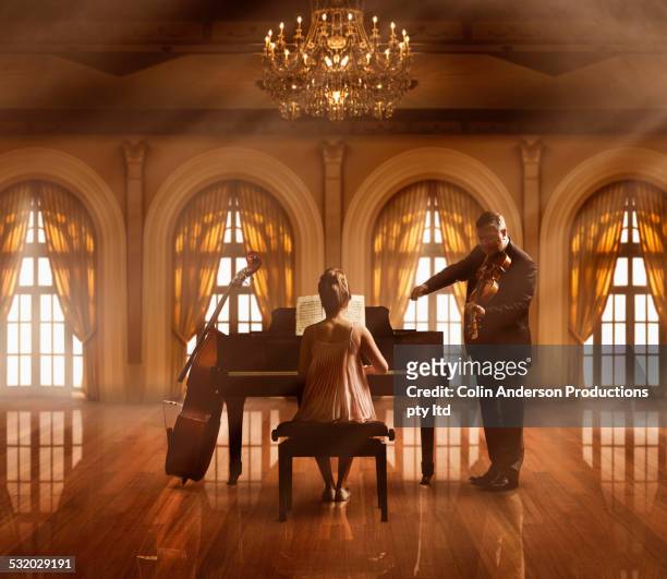 caucasian musicians playing piano and violin - piano concert stock pictures, royalty-free photos & images