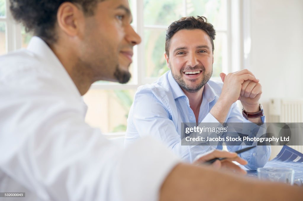 Business people talking at conference table