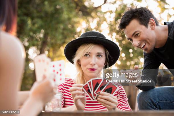 friends playing card game in backyard - id cards stock-fotos und bilder
