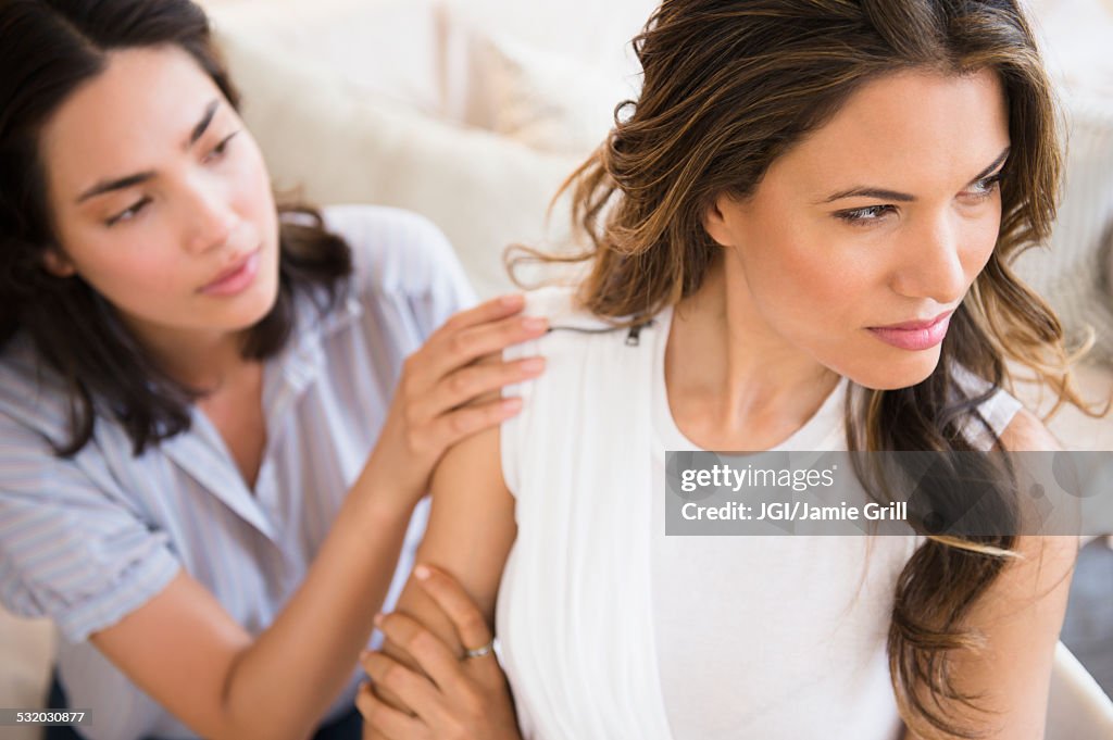 Hispanic woman comforting angry friend