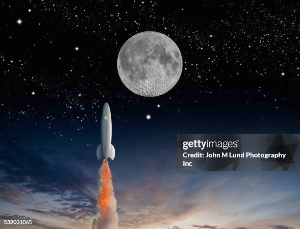 rocket launching into outer space - cohete espacial fotografías e imágenes de stock