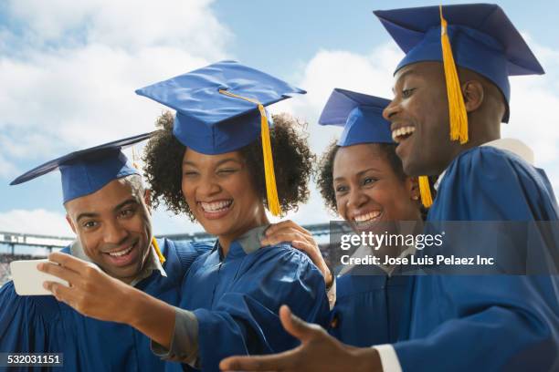 students taking cell phone selfie at graduation - graduation group stock pictures, royalty-free photos & images