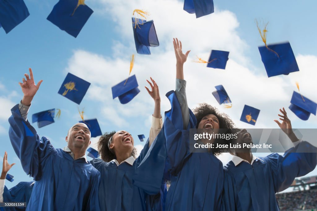Students throwing caps at graduation