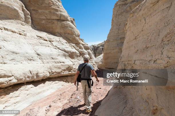older caucasian man exploring rock formations - canyon stock pictures, royalty-free photos & images