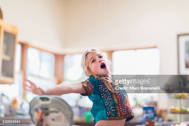 caucasian girl singing indoors - child singing stock-fotos und bilder