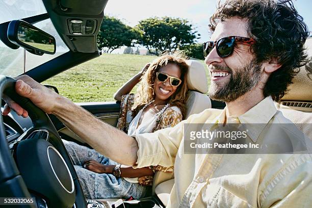 couple driving together in convertible - man driving sports car stock pictures, royalty-free photos & images