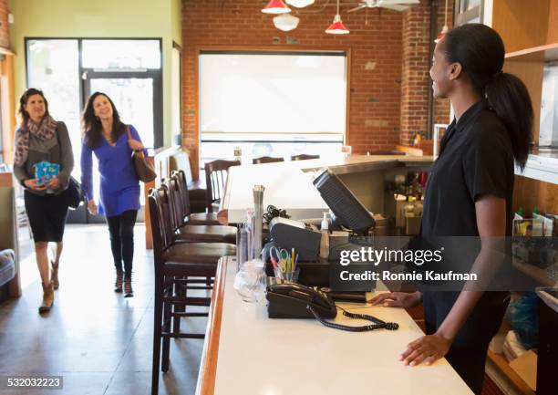 server greeting customers in restaurant - welcome to los angeles stock pictures, royalty-free photos & images