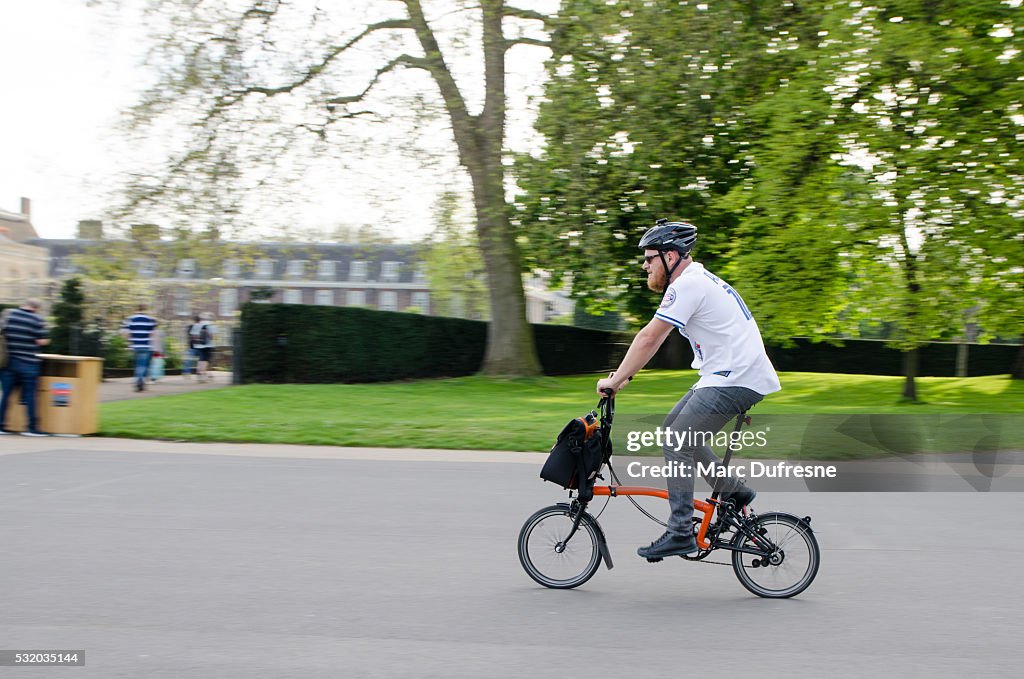 Man on foldable bicycle passing by