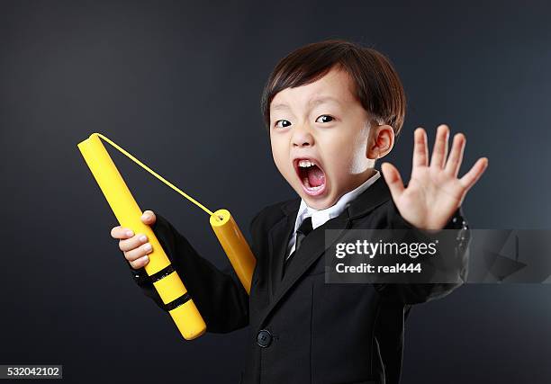 cute asia child kung fu - nunchucks stock pictures, royalty-free photos & images