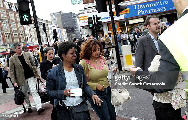 Evacuated tube passengers fill the street at Edgware Road following an explosion which ripped through London's inderground tube network on July 7,...