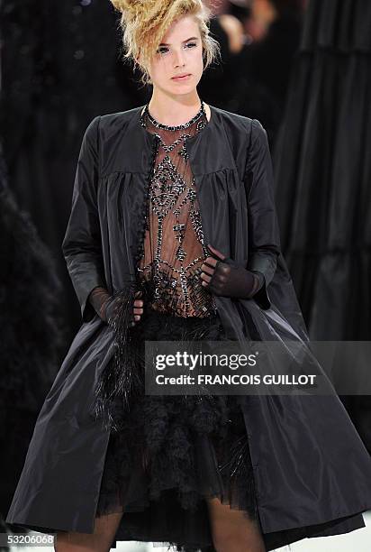 A model displays a creation by Karl Lagerfeld for Chanel Fall