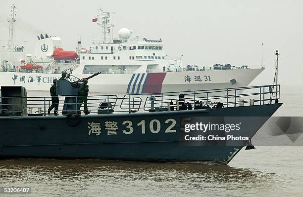 The Haijing 31025, a ship with China's marine police, escorts the Haixun 31, China's biggest and most advanced patrol ship with the Maritime Safety...