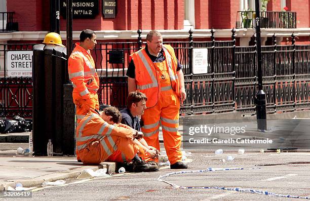 Emergency workers attend the scene near Edgware Road station following a series of explosions which ripped through London's underground tube network...