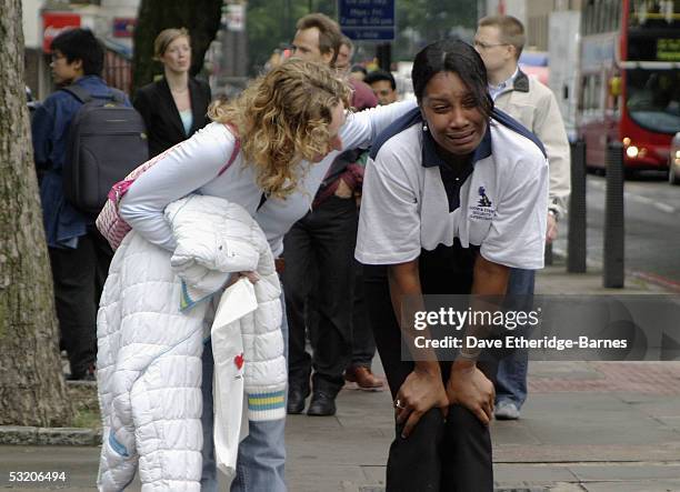 Distraught commuter is consoled near to Euston station after a series of explosions ripped through London's transport network on July 7, 2005 in...