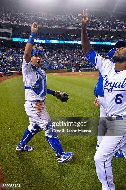 Salvador Perez of the Kansas City Royals does his special handshake with teammate Lorenzo Cain after the game in which the Royals defeated the Boston...