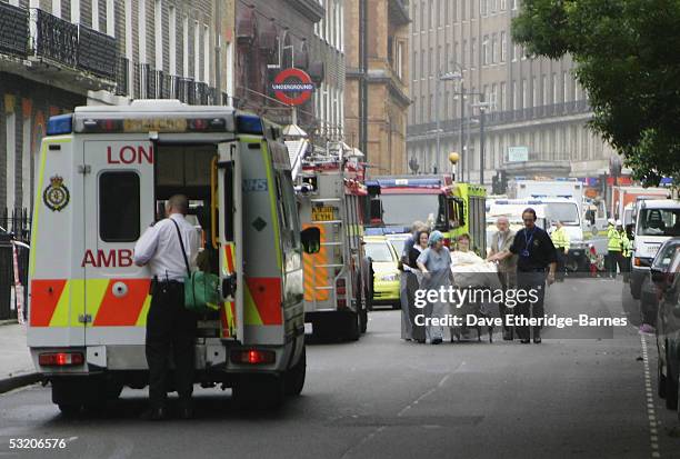 Emergency Services assist a victim at the scene near Russell Square underground station after a series of explosions ripped through London's...