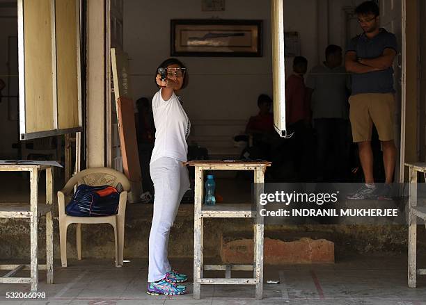 Shooting', INTERVIEW by Peter HUTCHISON In this photograph taken on April 25 Indian shooter Heena Sidhu takes aim during a training session at the...