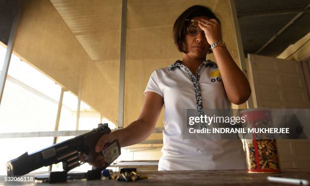 Shooting', INTERVIEW by Peter HUTCHISON In this photograph taken on April 25 Indian shooter Heena Sidhu takes part in a training session at the...