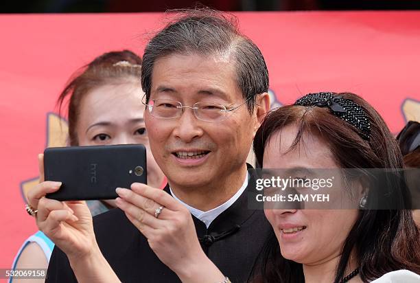 Pro-unification activist Chang An-lo, also as known as White Wolf, poses for a photo with his supporters during a protest outside the ruling...