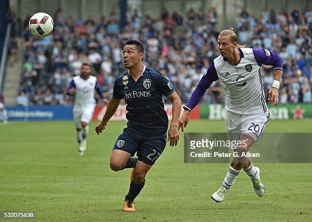 Mid-fielder Roger Espinoza of Sporting Kansas City makes a play on the ball against forward Brek Shea of Orlando City SC during the second half on...