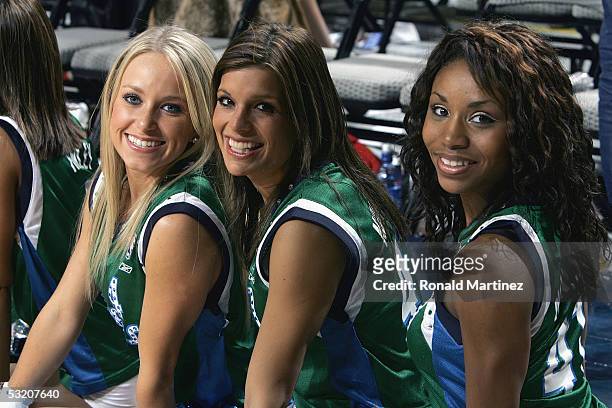 Members of the Dallas Mavericks Dancers watch the action during the game against the Atlanta Hawks on December 18, 2004 at the American Airlines...