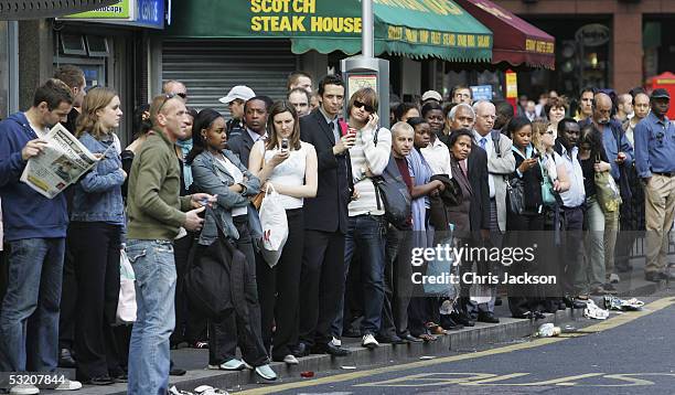 Crowds of Commuters queue at victoria station for the first buses after service was resumed as they make their way home following a series of blomb...