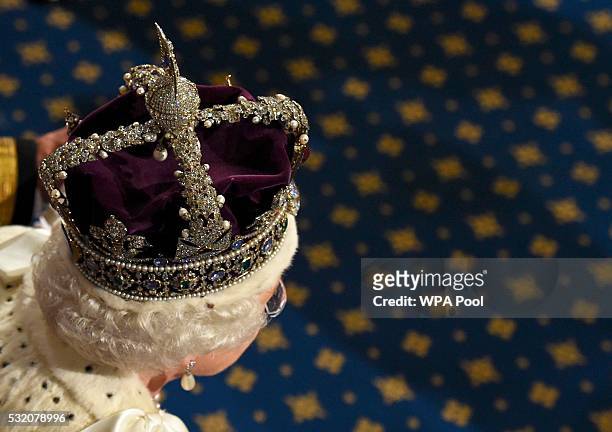 Queen Elizabeth II proceeds through the Royal Gallery after she addressed the State Opening of Parliament in the House of Lords at the Palace of...