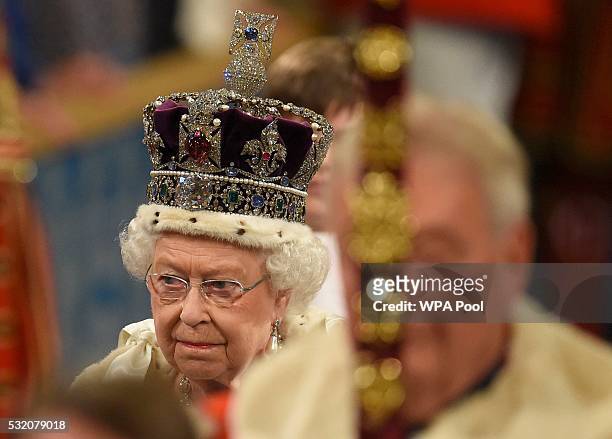 Queen Elizabeth II proceeds through the Royal Gallery before the State Opening of Parliament in the House of Lords at the Palace of Westminster on...