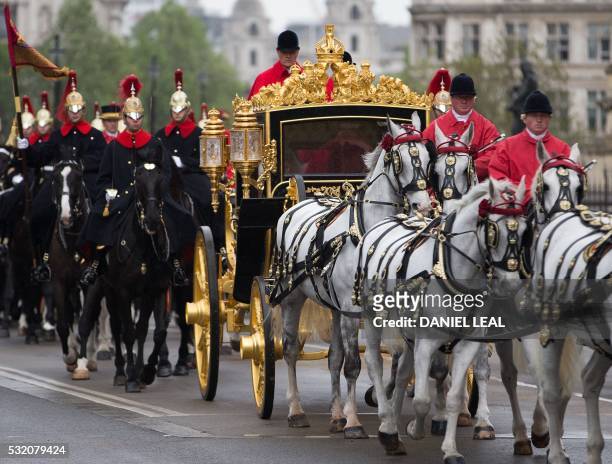 Britain's Queen Elizabeth II and Prince Philip, Duke of Edinburgh, travel in the Jubilee State Coach as they prepare to attend the State Opening of...