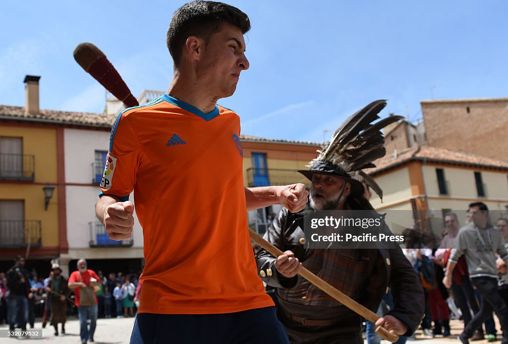 A man pictured wearing a hat decorated with vulture feathers...