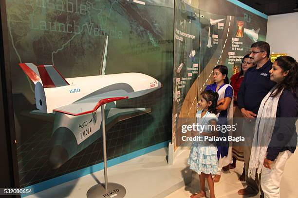 Members of the public look at a model of India’s first re-usable Launch Vehicle or 'Space Shuttle' at Vikram Sarabhai Space Center on March 30, 2016...