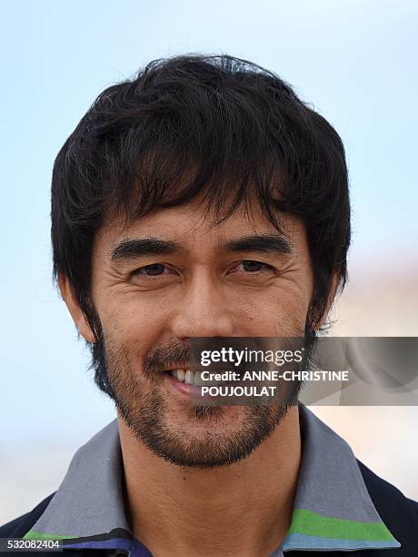 Japanese actor Abe Hiroshi smiles on May 18, 2016 during a photocall for the film "After the Storm " at the 69th Cannes Film Festival in Cannes,...