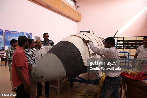 Scientists and technicians work on India’s first re-usable Launch Vehicle or 'Space Shuttle' as it sits in a laboratory at Vikram Sarabhai Space...