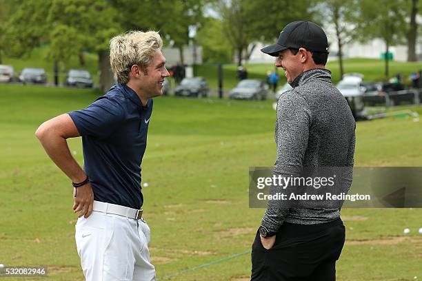 Rory McIlroy of Northern Ireland chats to singer Niall Horan of One Direction on the range during a Pro-Am round prior to the start of the Dubai Duty...
