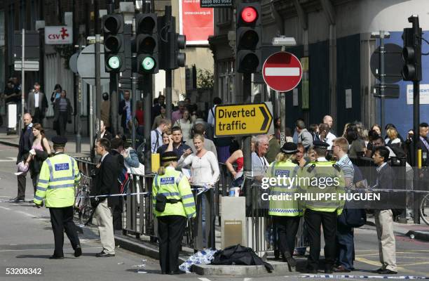 Police keep pedestrians away from Kings Cross Station in London after a bomb exploded on a subway train 07 July 2005. Explosions ripped through three...