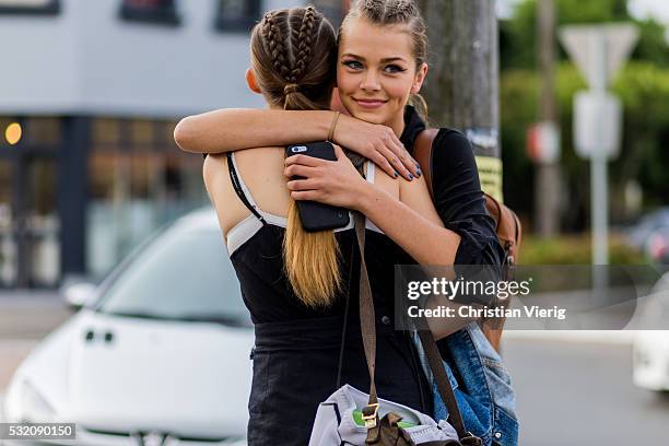 Models hugging with braided hair outside Yuxin at Mercedes-Benz Fashion Week Resort 17 Collections at Carriageworks on May 18, 2016 in Sydney,...